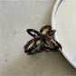 Beau Misty Acetate Butterfly Hair Clip clipped in brunette hair with natural light