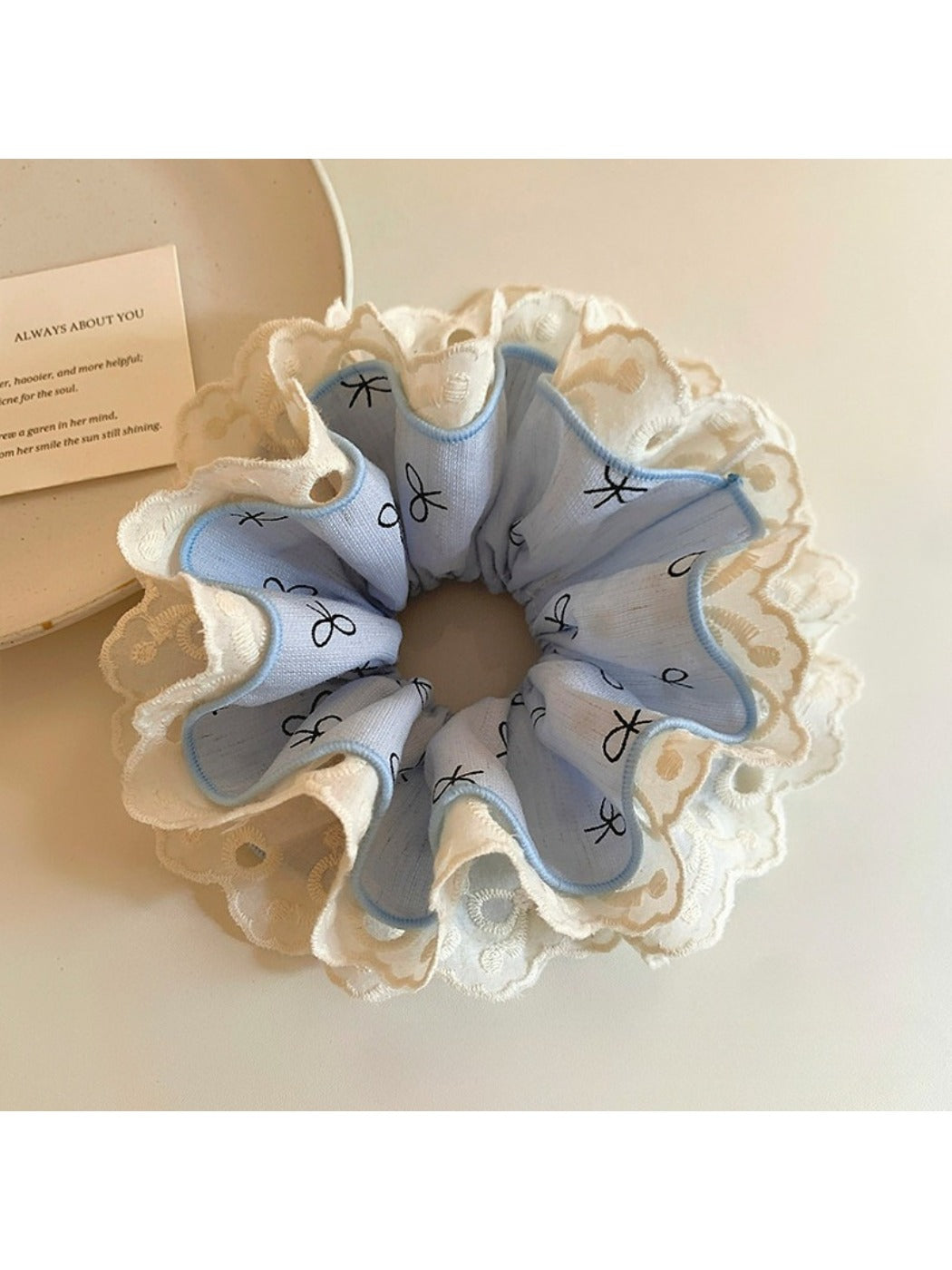 Close-up of Gifty bow print ruffled scrunchie in pastel colors on white background