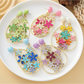 Close-up of Earedge floral raffia statement drop earrings on white background