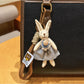 Rabbit charm keychain held in hand showing size and scale