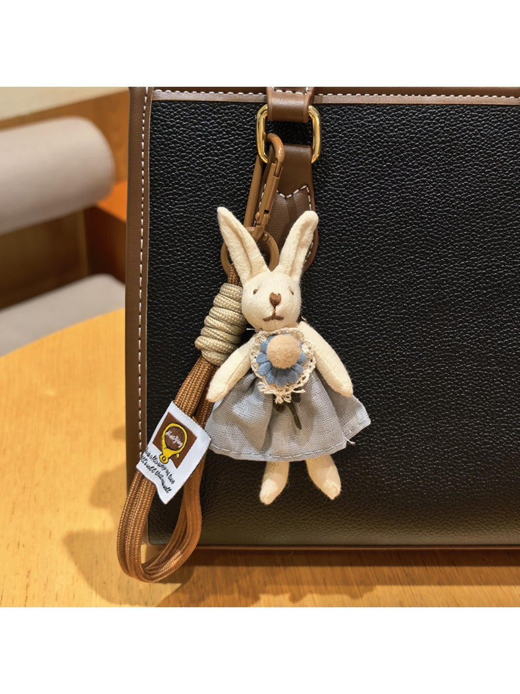 Rabbit charm keychain held in hand showing size and scale