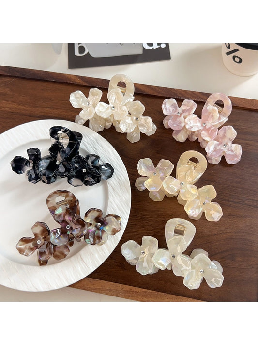 Beau elegant floral hair claw clip in cream and gold tones on white background