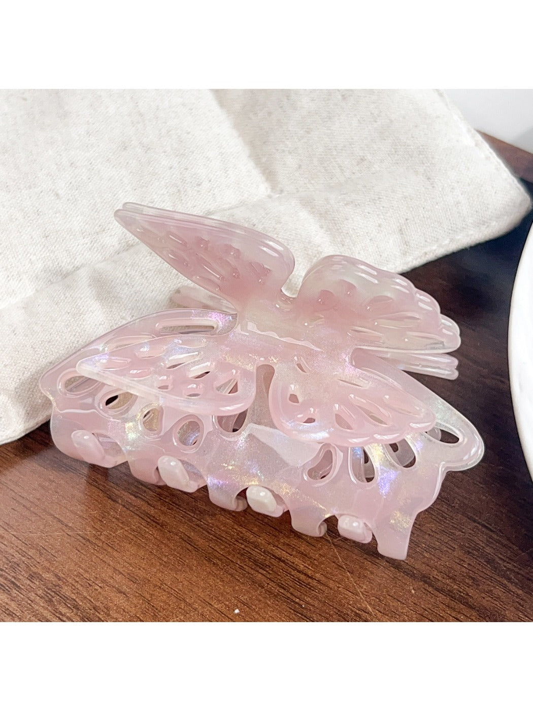 Beau butterfly hair claw clip photographed with soft natural lighting and shadows