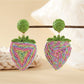 Detailed shot of green raffia leaves on strawberry earrings