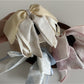 Side view of Beau bow ribbon streamer claw clip highlighting the claw mechanism