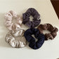 Gifty scrunchie styled on a wrist showing its lively and colorful design
