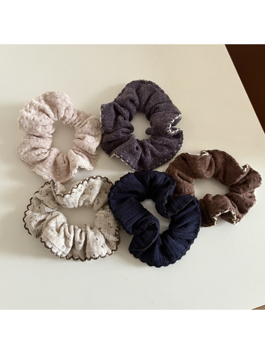Gifty scrunchie styled on a wrist showing its lively and colorful design