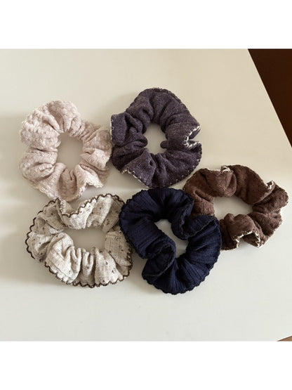 Gifty scrunchie styled on a wrist showing its lively and colorful design