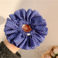 Gifty polka dot scrunchie styled on a wrist with ruffled edges visible