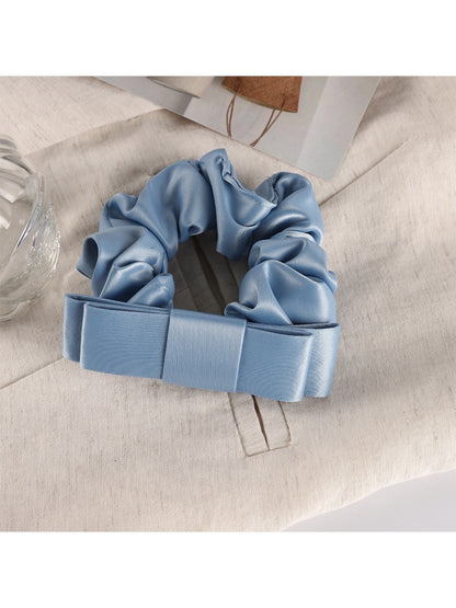 Scrunchie paired with matching pastel accessories on a light surface