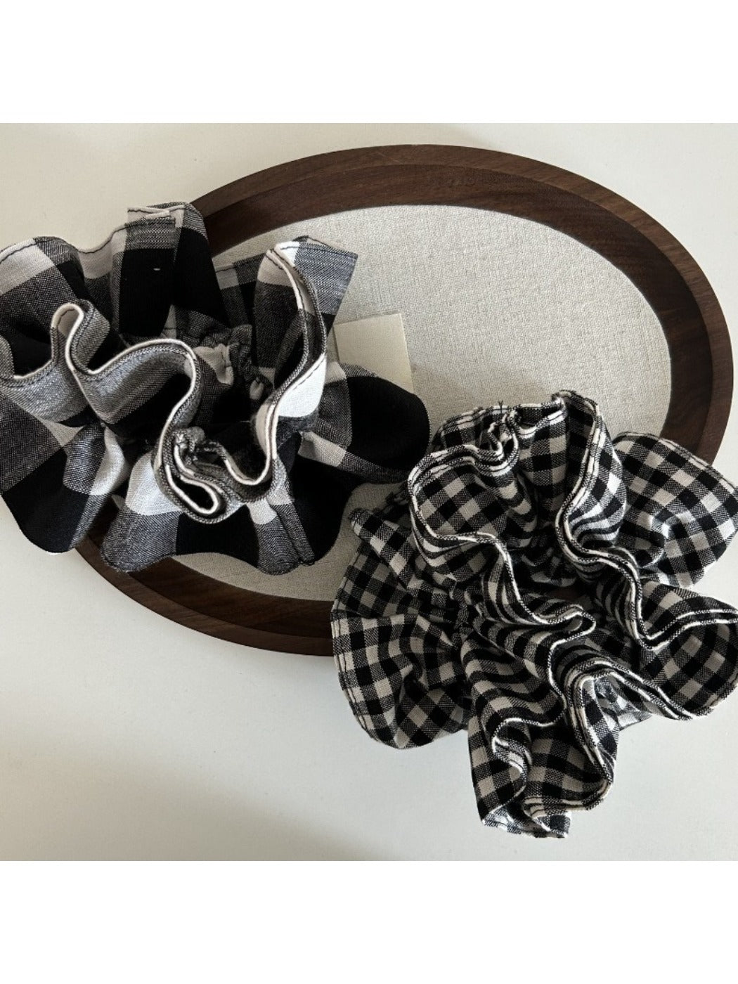 Vintage scrunchie with black and white check pattern displayed flat