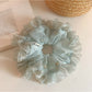 Gifty polka dot scrunchie displayed on a white background showing ruffled tulle texture