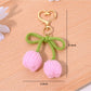Keypus bouquet and tulip shaped keychains displayed together on a wooden surface
