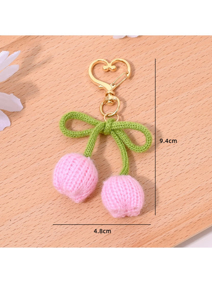 Keypus bouquet and tulip shaped keychains displayed together on a wooden surface