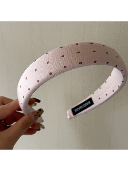 Gifty headband placed next to matching accessories on wooden surface