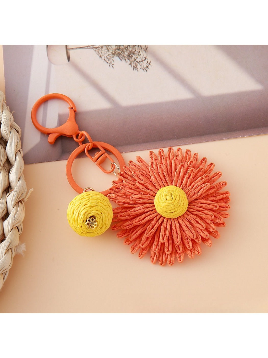 Sunflower keychain with metal ring and natural raffia petals in bright lighting