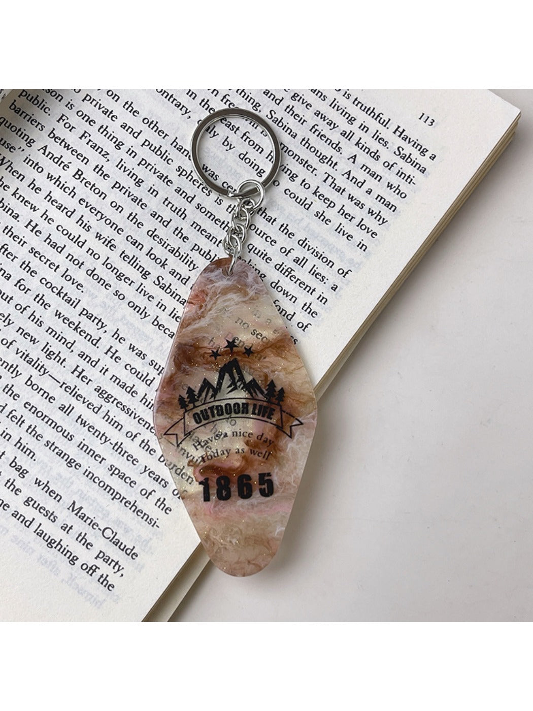 Colorful diamond pendant keychain shown with keys and a wallet on a table