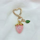 Keypus strawberry charm keychain close-up showing realistic strawberry design
