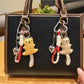 Close-up of the bear keychain's face showing detailed eyes and nose stitching