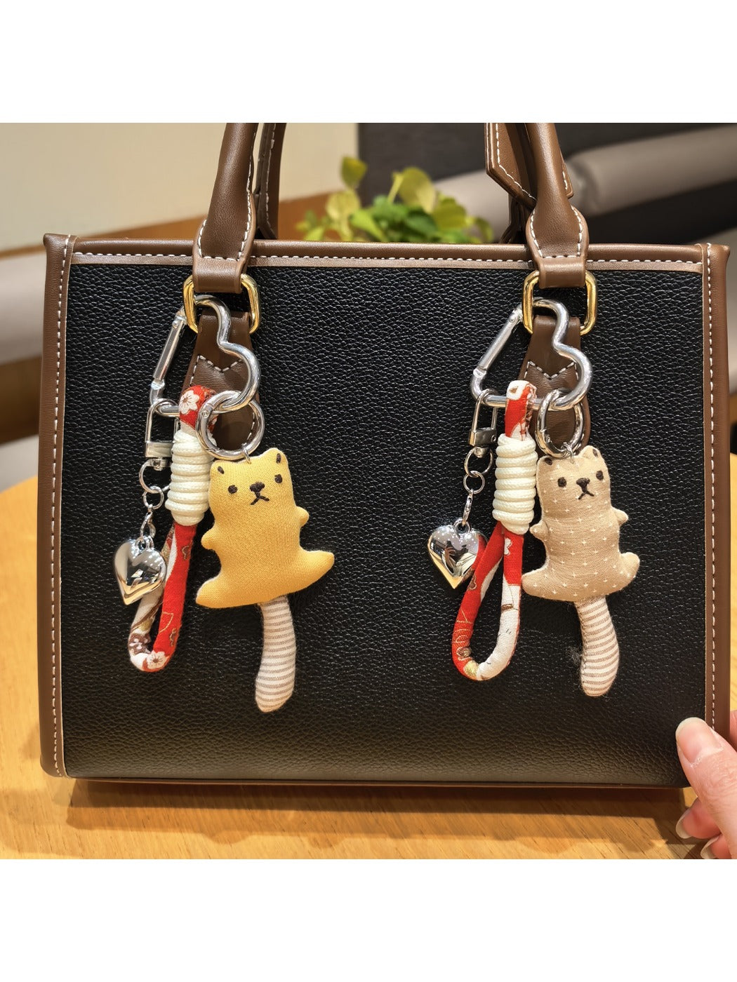 Close-up of the bear keychain's face showing detailed eyes and nose stitching
