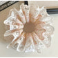 Gifty light pink scrunchie stretched to show elastic band