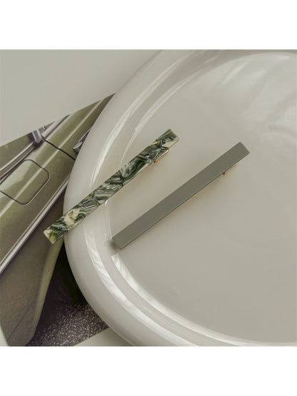Beau acetate hair clip displayed alongside matching accessories on neutral background