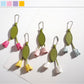 Close-up of a cute tulip flower shaped keychain with pink petals and green leaves