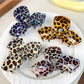 Close-up of Beau hair claw clip showing leopard print and bow shape