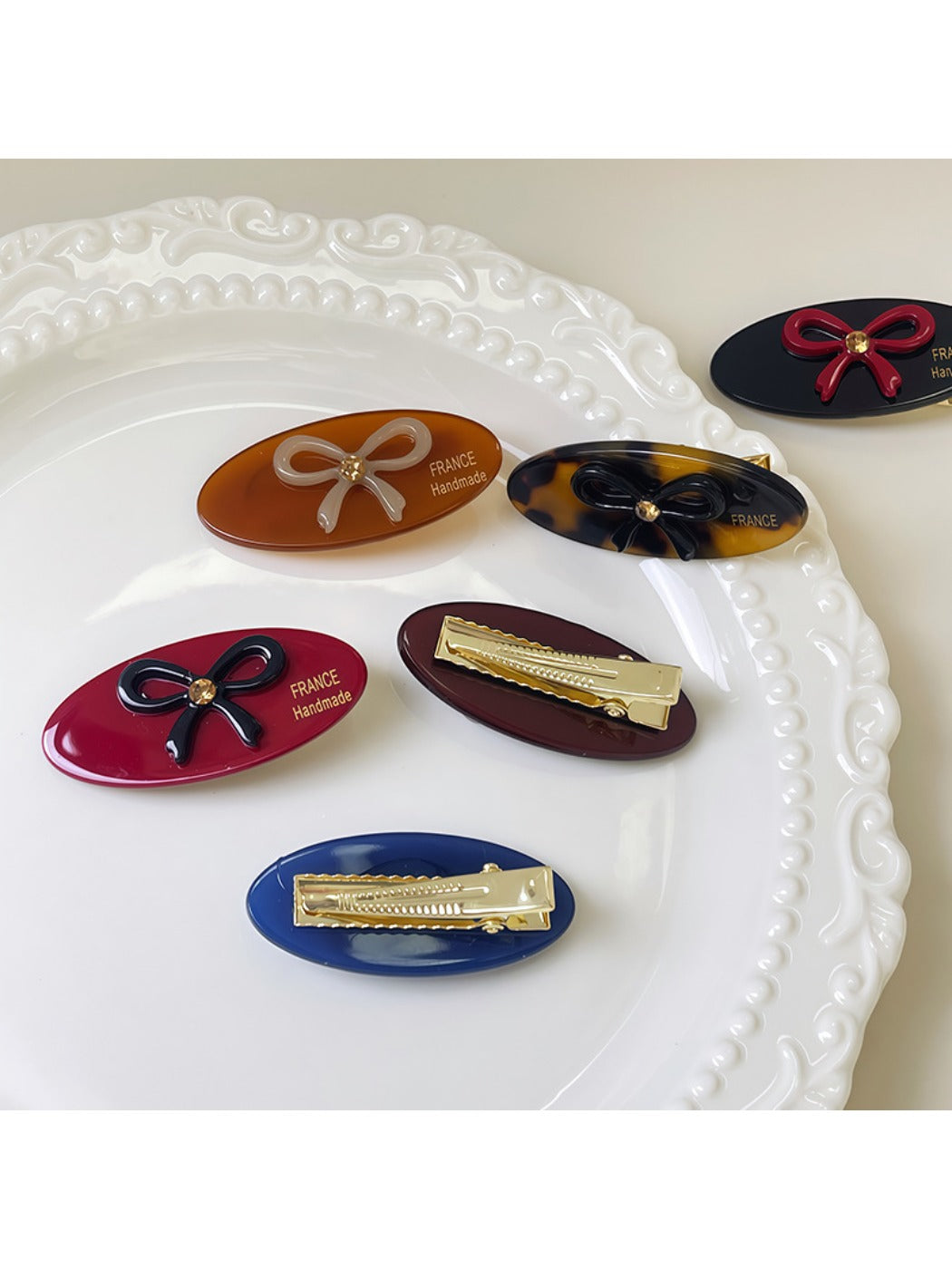 Beau hair clip held in hand displaying size and oval butterfly shape