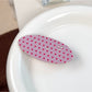 Beau pink polka dot hair claw clip displayed with matching hair accessories