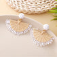 Earedge raffia fan shaped drop earrings laid flat showing natural fibers