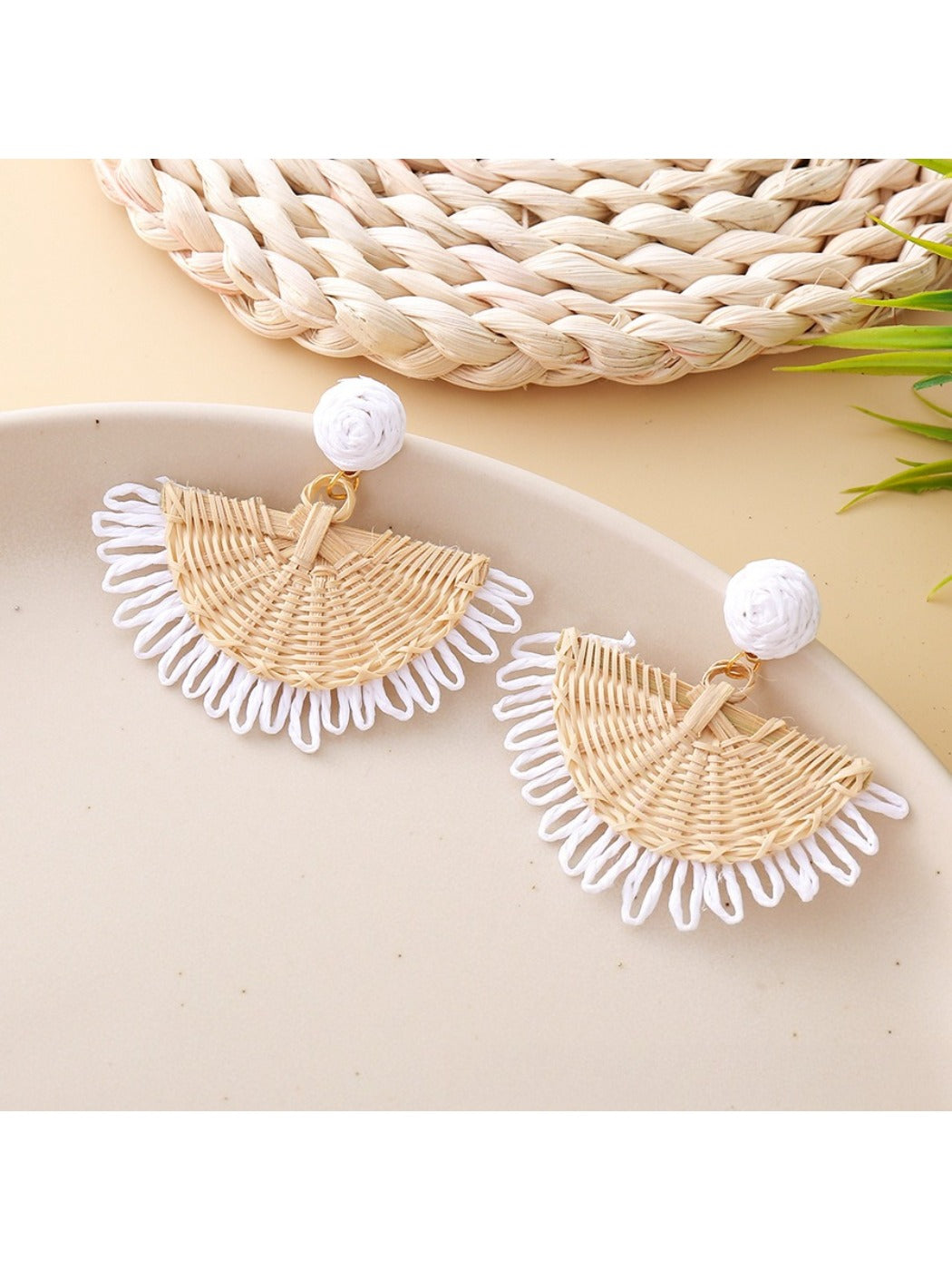 Earedge raffia fan shaped drop earrings laid flat showing natural fibers