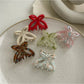 Close-up of Beau butterfly claw clip showing detailed acetate material and clasp mechanism