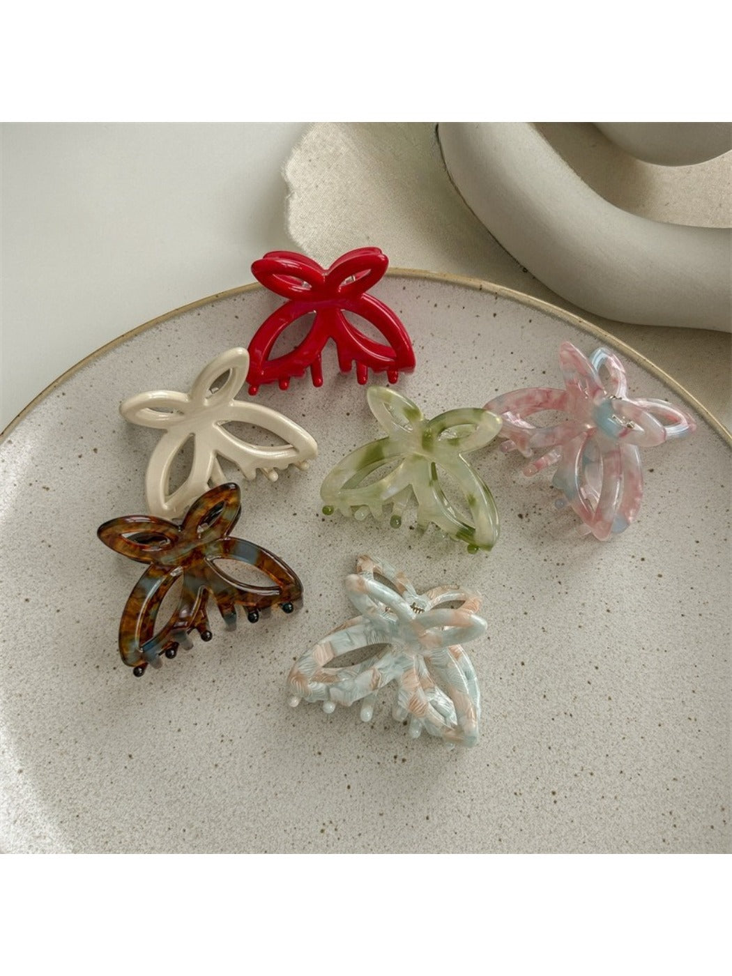 Close-up of Beau butterfly claw clip showing detailed acetate material and clasp mechanism