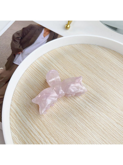 Beau sweet bow shaped hair claw clip photographed with soft shadows
