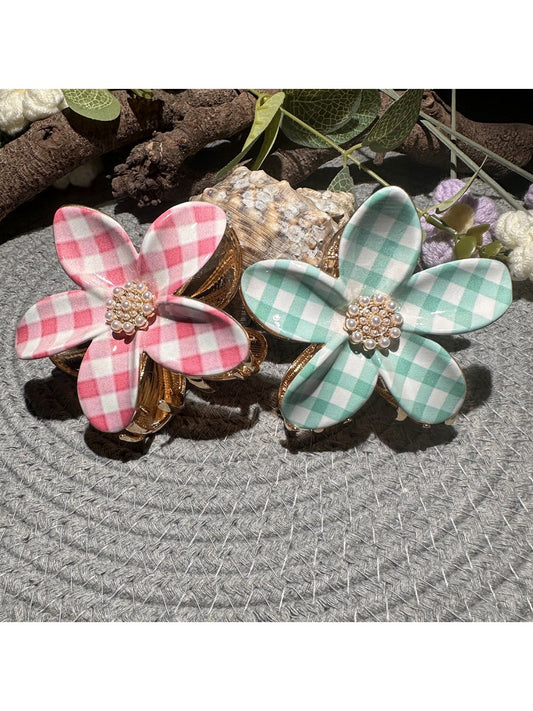 Beau checkered flower shaped hair clip with black and white pattern on a white background