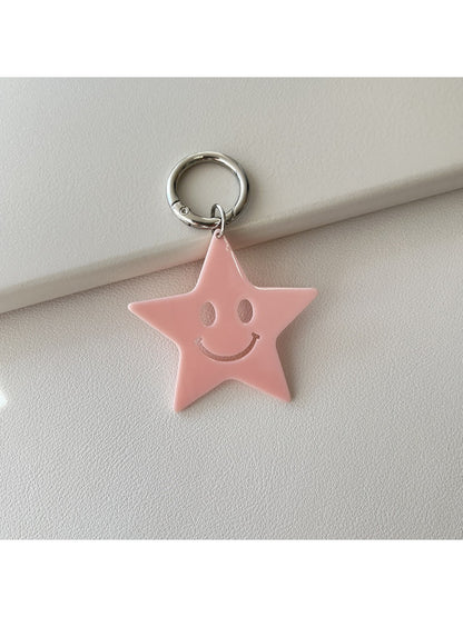 Silver star keychain hanging from a backpack zipper pull