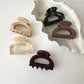 Beau vintage semi circular claw clip with intricate openwork design on a white background