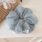 Gifty pink tulle scrunchie with white polka dots displayed on white background