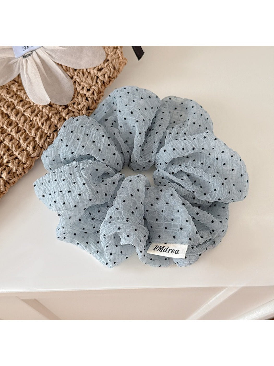 Gifty pink tulle scrunchie with white polka dots displayed on white background