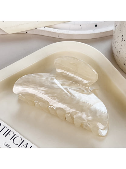 Beau crescent claw clip shown open to display metal spring mechanism