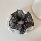 Side view of Gifty lace trim scrunchie highlighting fabric texture and floral design