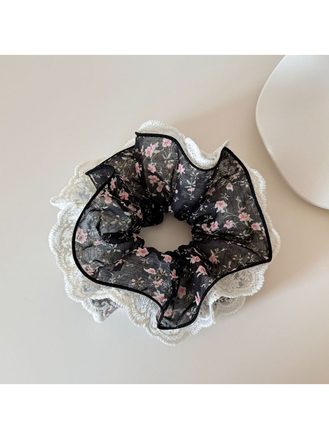 Side view of Gifty lace trim scrunchie highlighting fabric texture and floral design