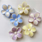 Side view of Beau color block flower claw clip highlighting curved petals and clasp