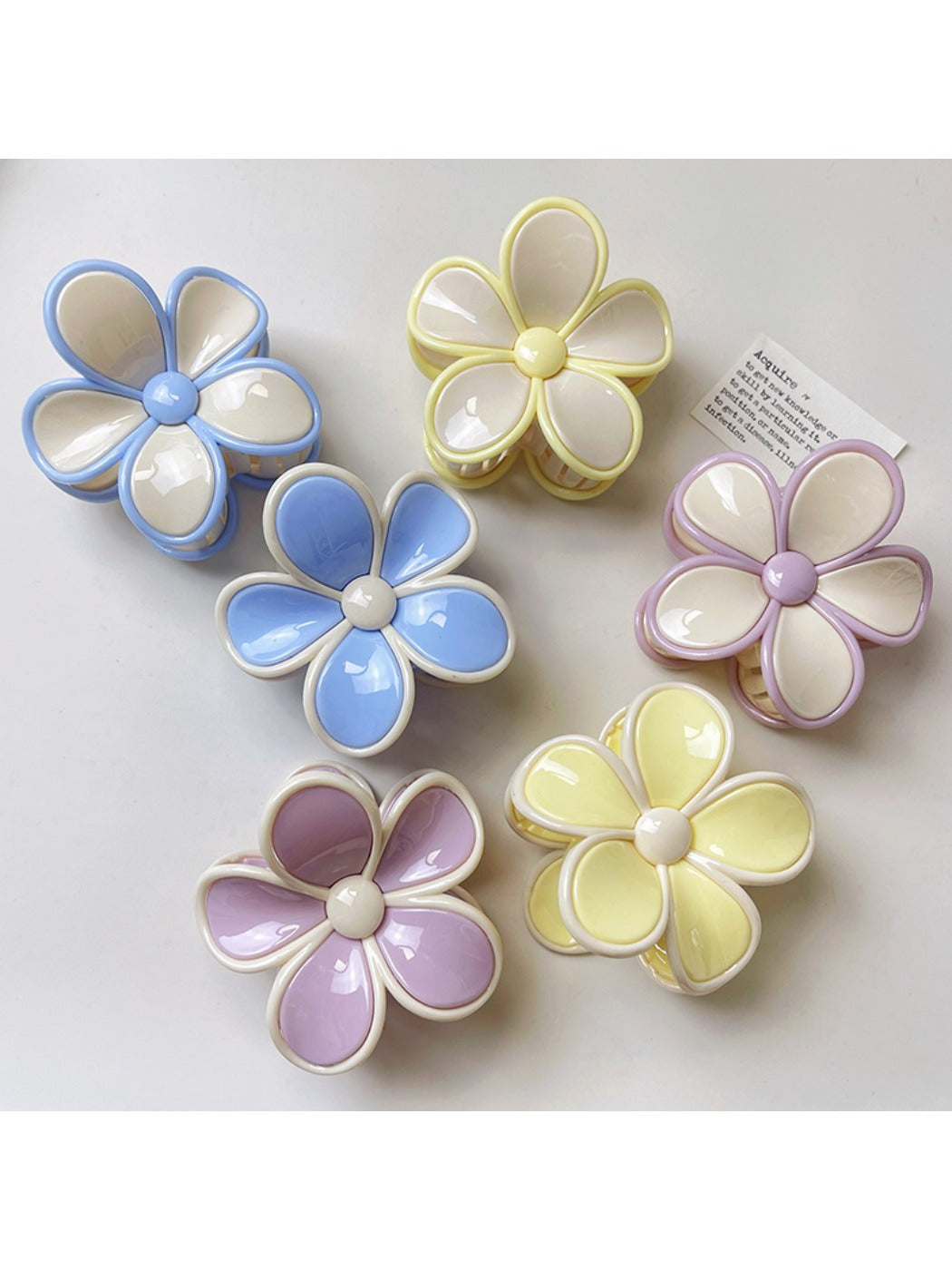 Side view of Beau color block flower claw clip highlighting curved petals and clasp