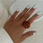 Lovra solid color open cuff bracelet and ring set displayed on a flat surface