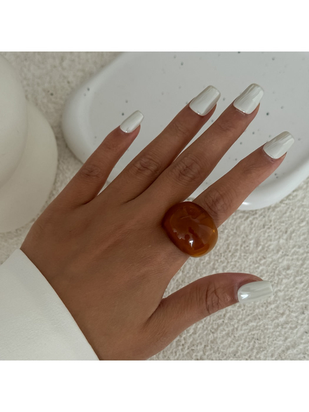 Lovra solid color open cuff bracelet and ring set displayed on a flat surface