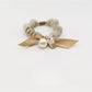 Close-up of Gifty Sweet Bow Embellished Hair Tie with pink fabric and pearl accents