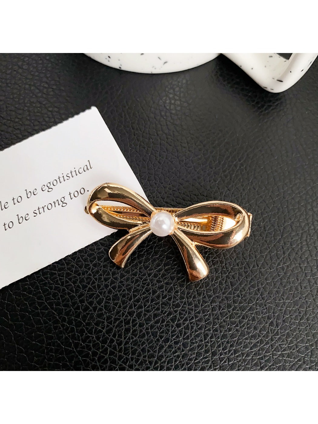 Beau classic bow hair clip in cream color displayed with matching accessories
