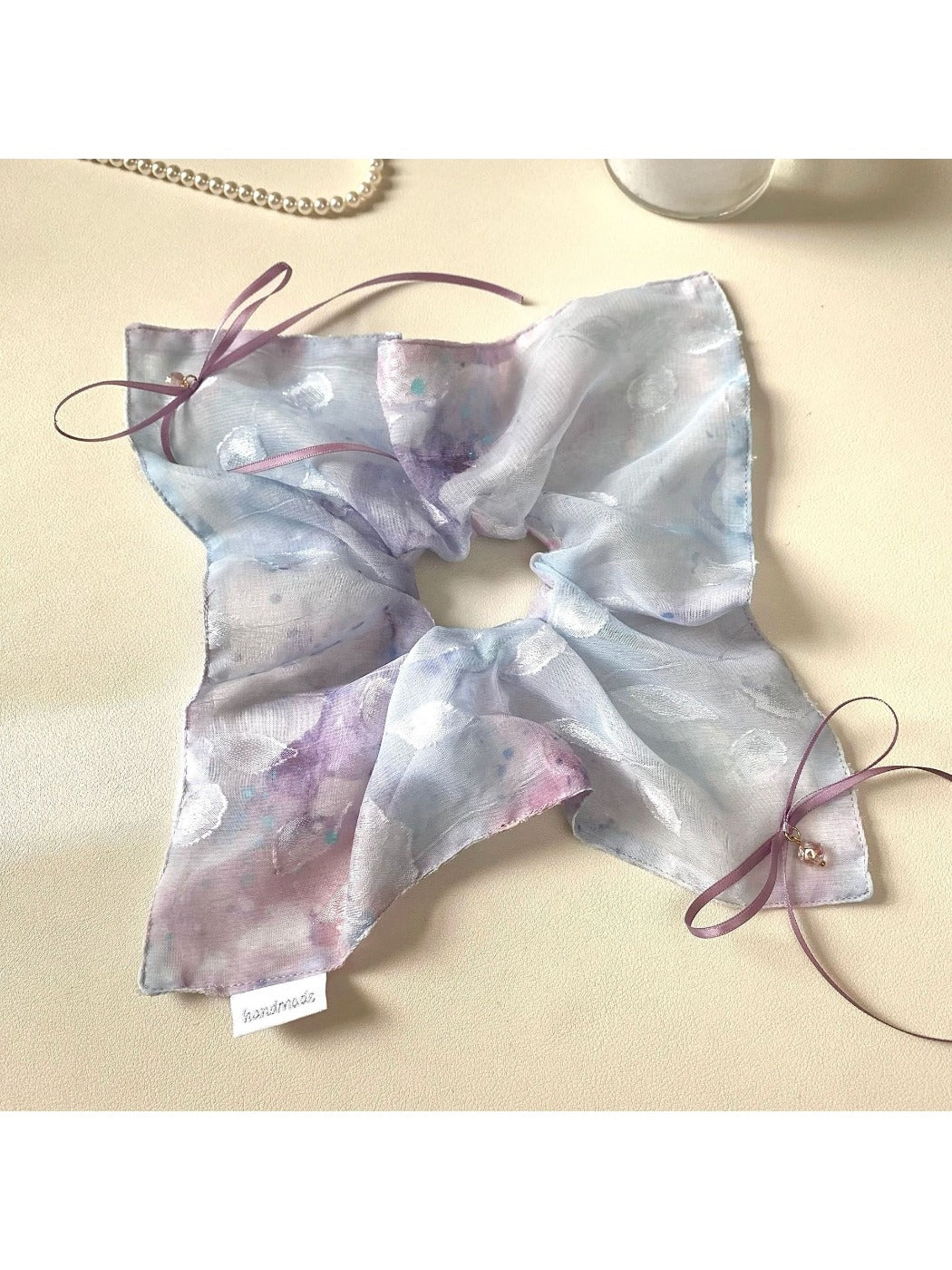 Flat lay of multiple Gifty ombre scrunchies in different pastel shades